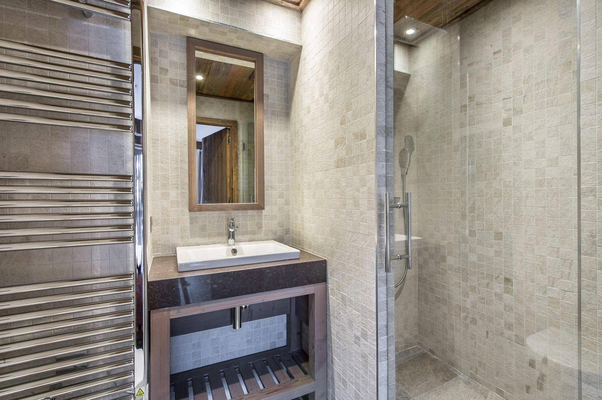 Bathroom featuring walk-in glass shower and heated towel rail