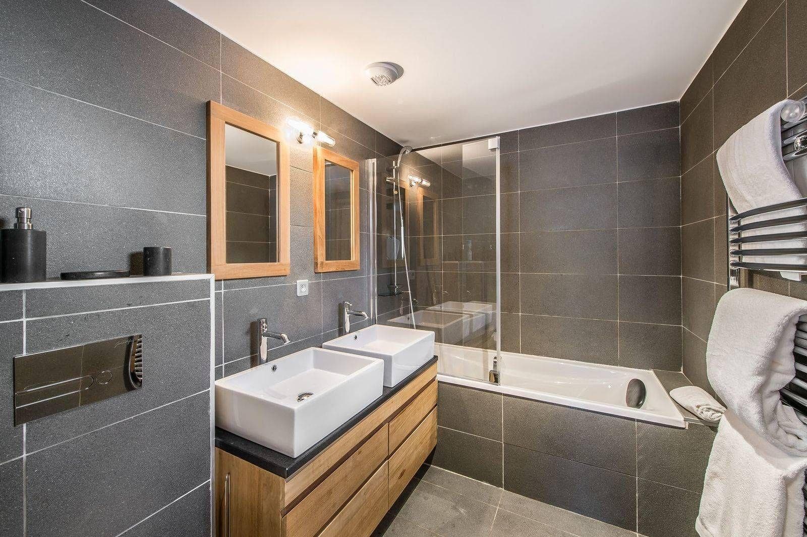 Bathroom with bath, double basin and heated towel rail