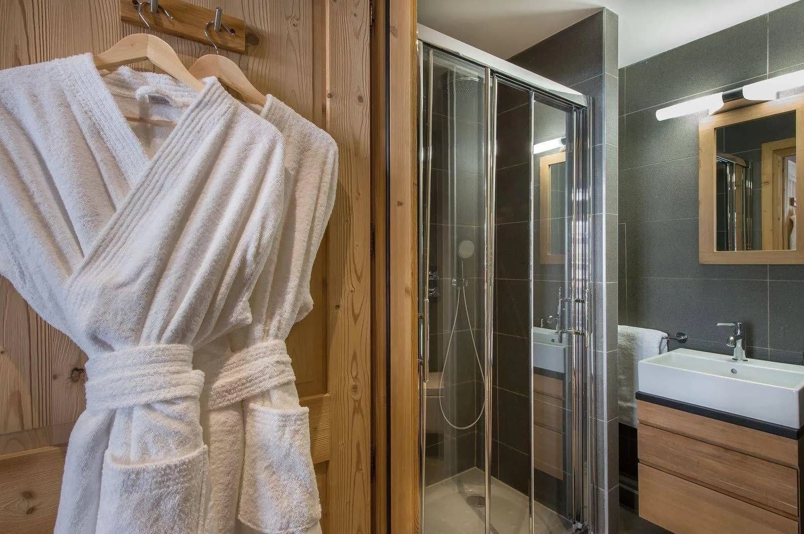 Shower room with basin, heated towel rail and bathrobes