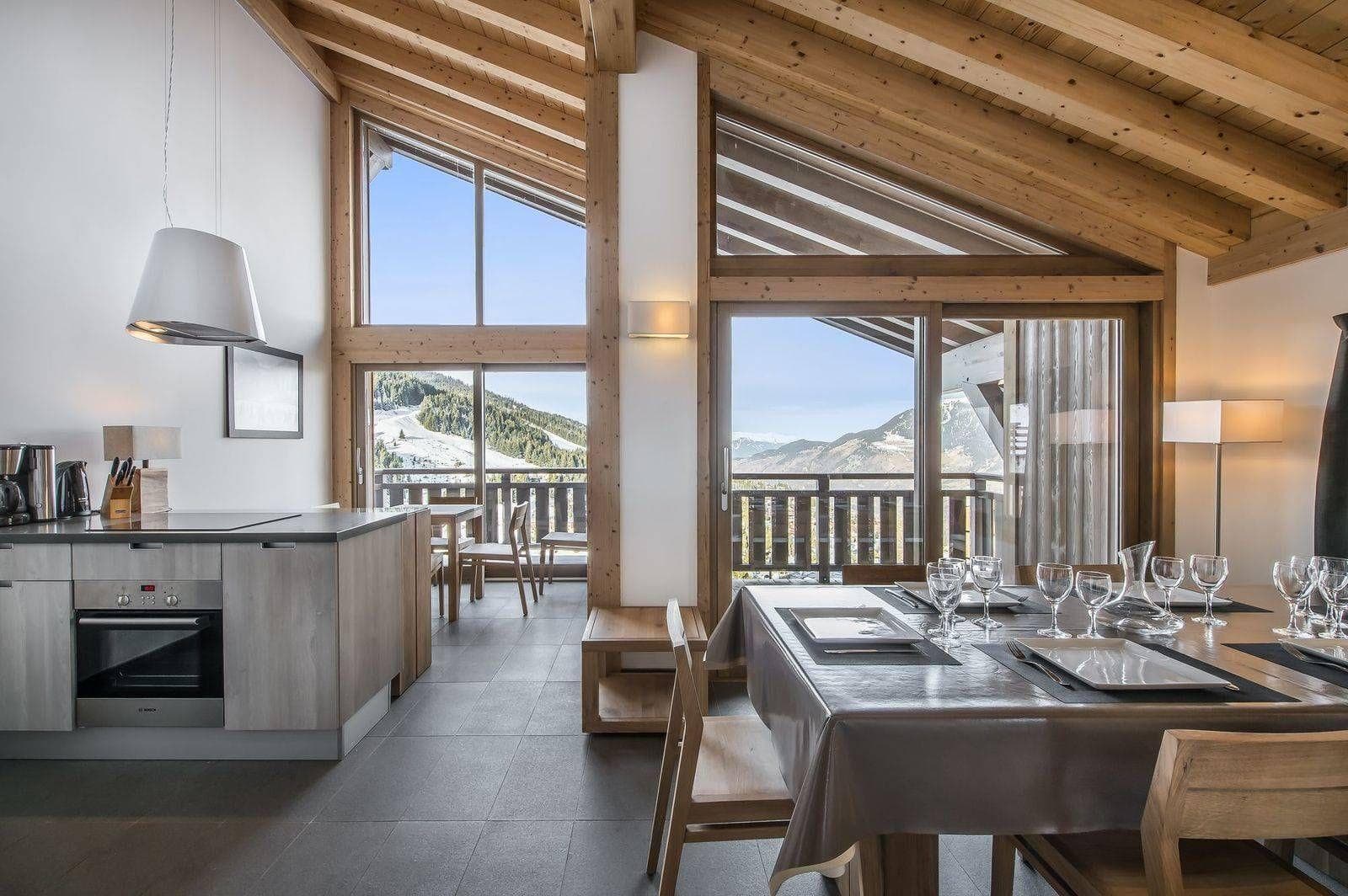 Open-plan dining area and kitchen with mountain views and balcony access