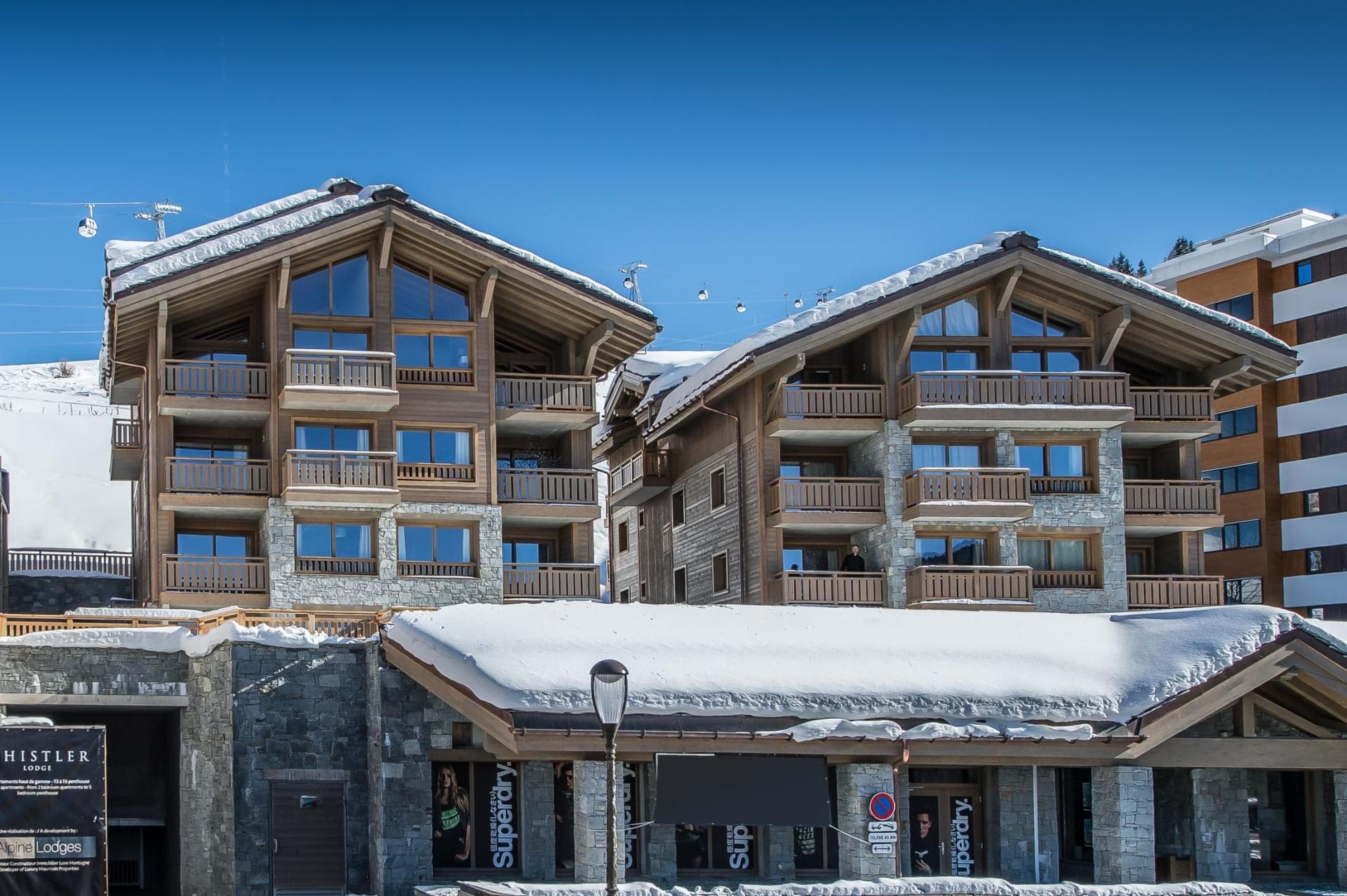 Ski-in/ski-out lodge exterior with private balconies and mountain lift access