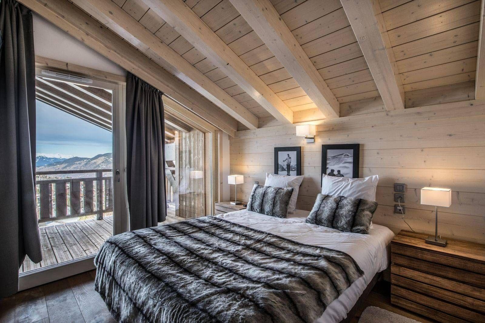 Top-floor bedroom with private balcony access and mountain views