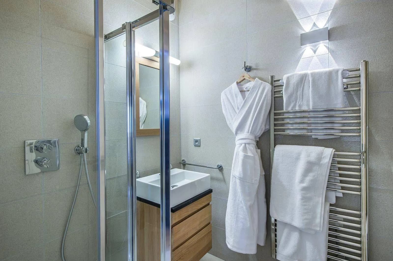 En-suite shower room with a heated towel rail and basin