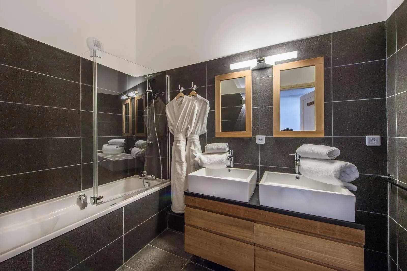 Independent bathroom with a bath, twin basins and heated towel rail