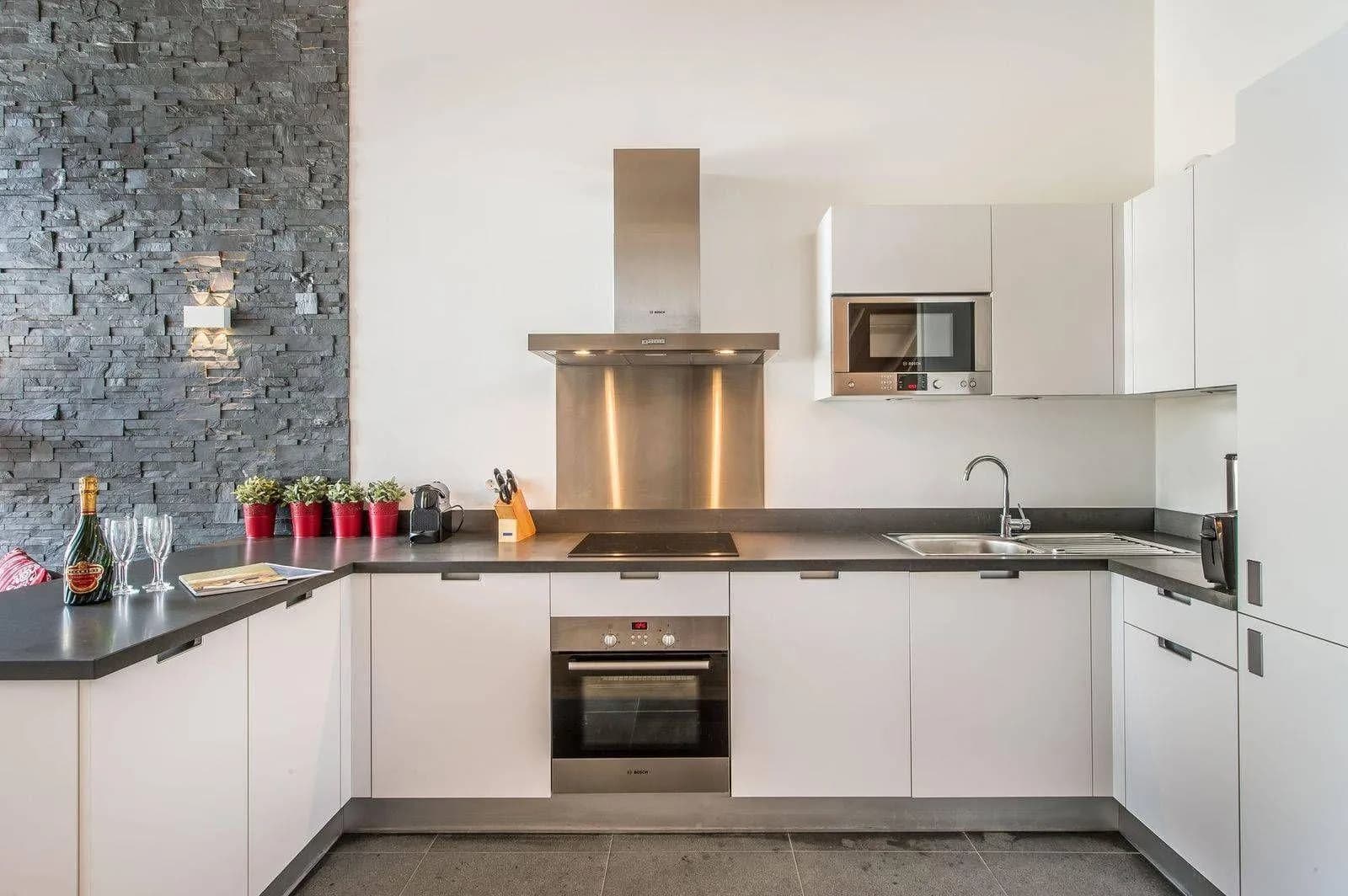 Open kitchen with integrated appliances and an induction hob