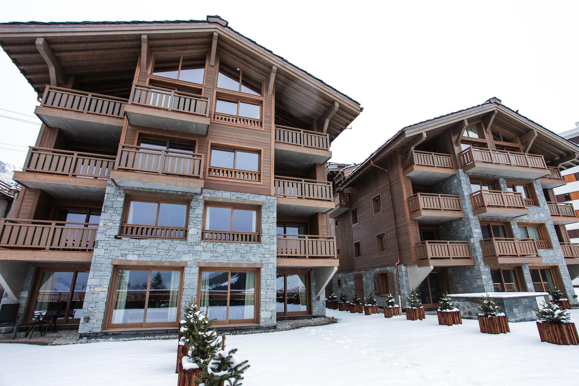Chalet exterior with private balconies and natural stone facade