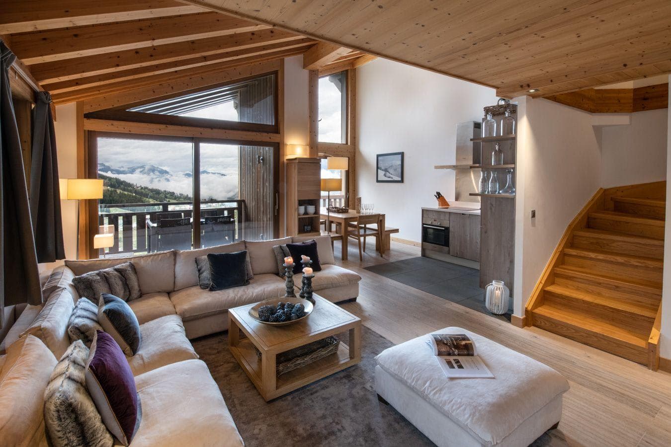 Open-plan living area with vaulted wood ceiling and mountain views