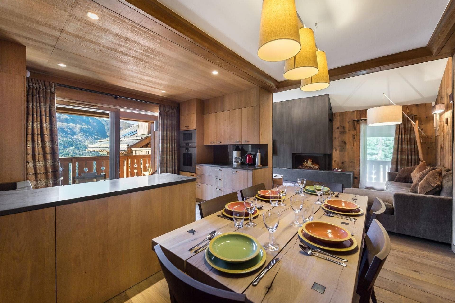 Open-plan dining area with seating for 8 near wood-burning fireplace