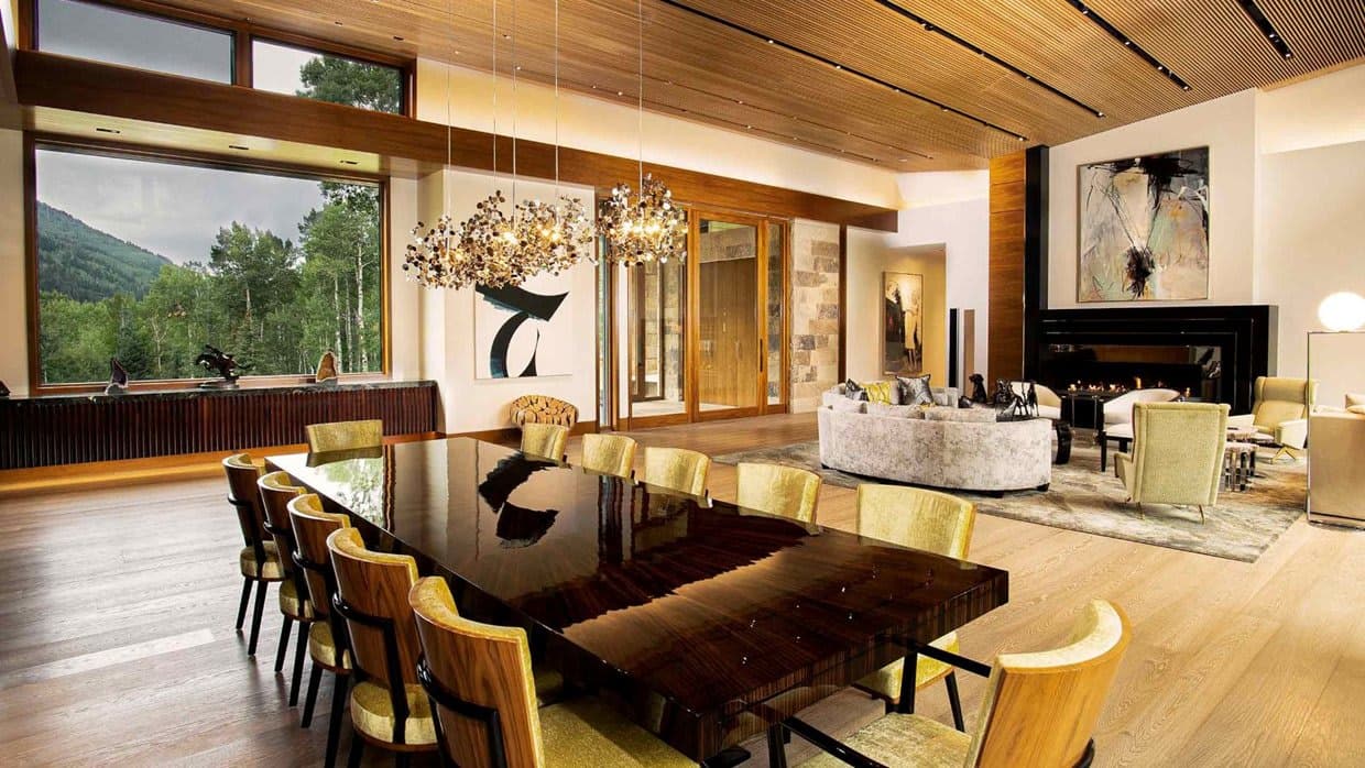 Open-plan dining area seating 10 with gas fireplace and mountain views