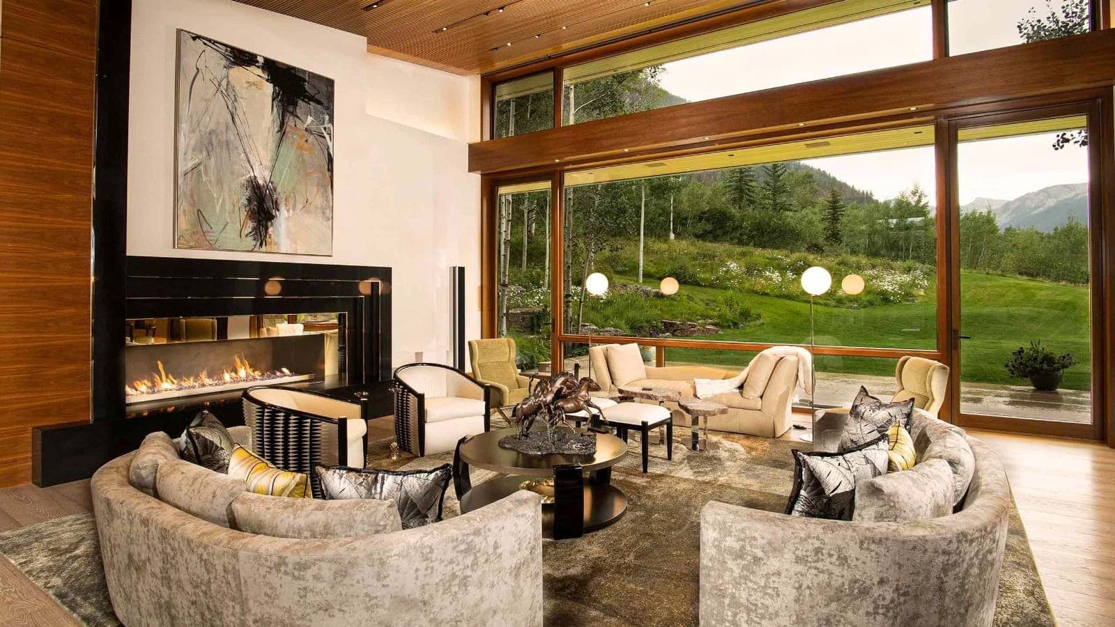 Living area with gas fireplace and floor-to-ceiling mountain views