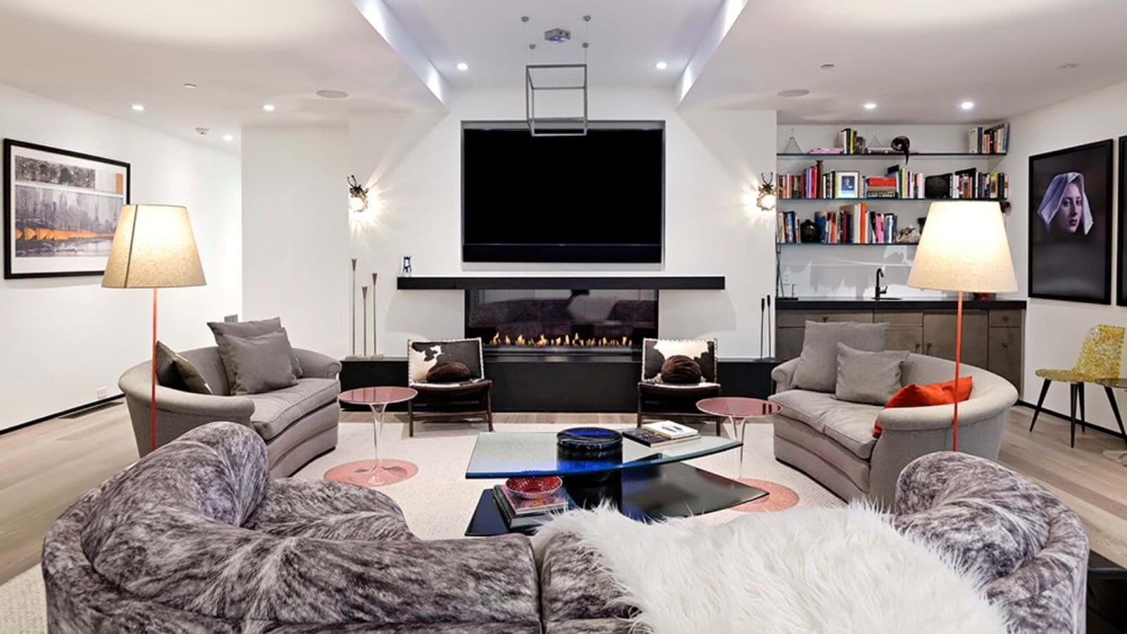 Media room with linear fireplace, smart TV, and wet bar