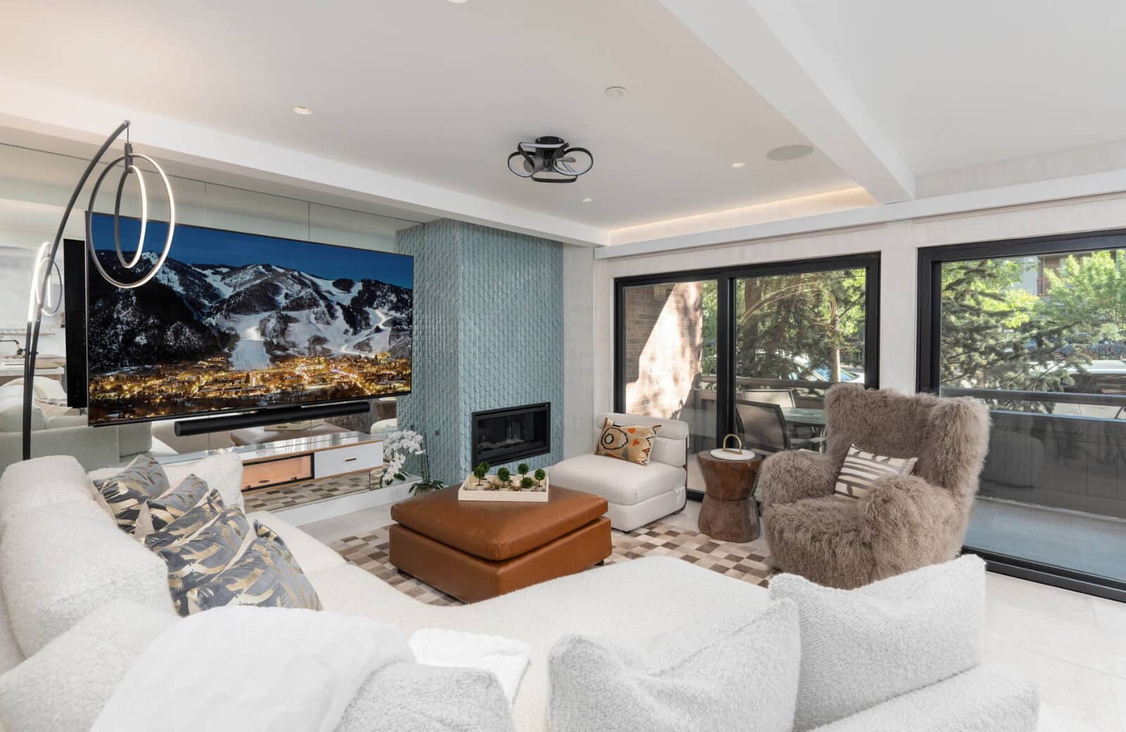 Living room with large screen TV, soundbar, and gas fireplace