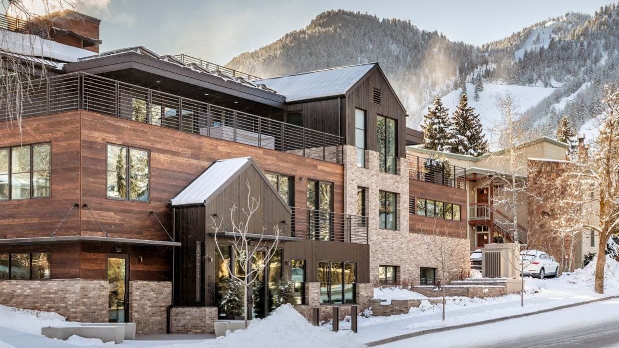 Ski-in lodge exterior with heated private balconies and mountain views
