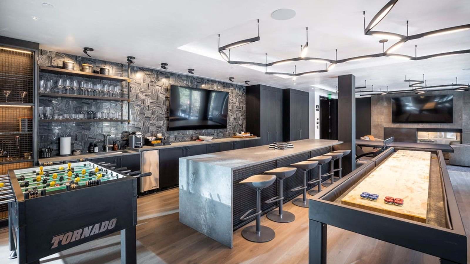 Game room with foosball, shuffleboard, and wet bar with wine fridge