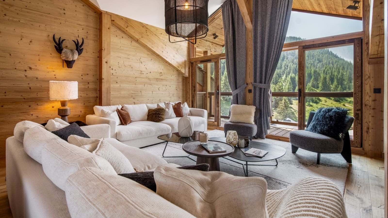 Living area with floor-to-ceiling windows and forest views