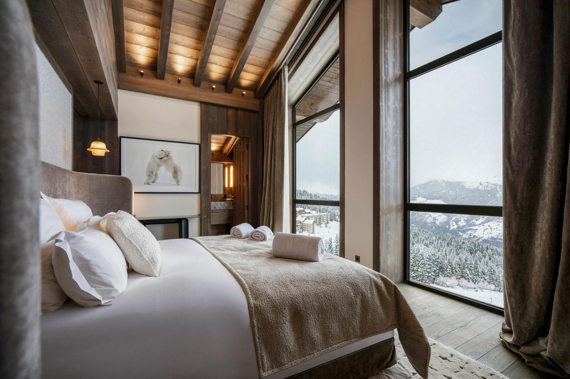 Primary bedroom with king bed and floor-to-ceiling snowy valley views