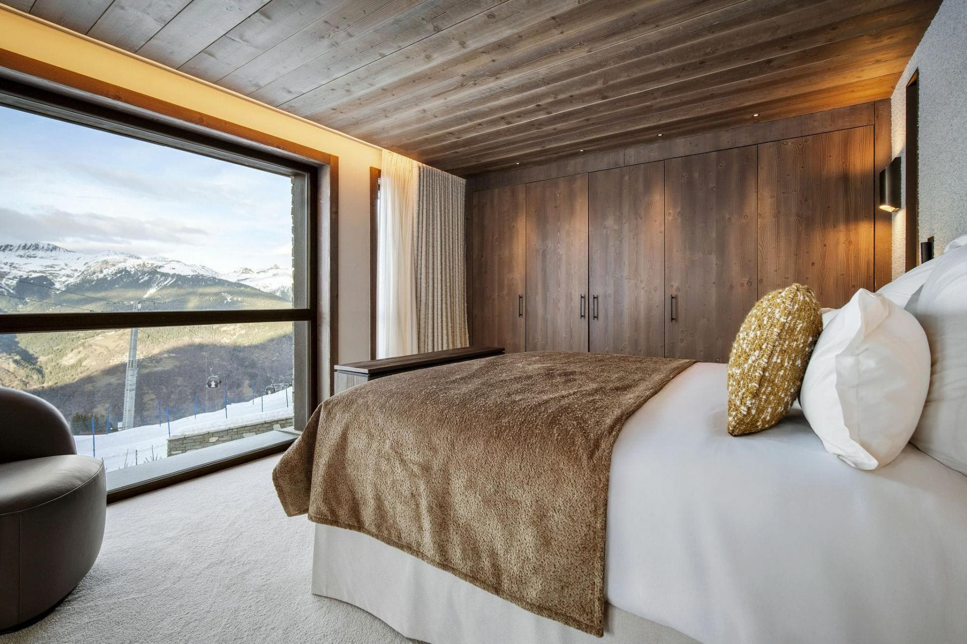 Primary bedroom with mountain views and floor-to-ceiling built-in wardrobes