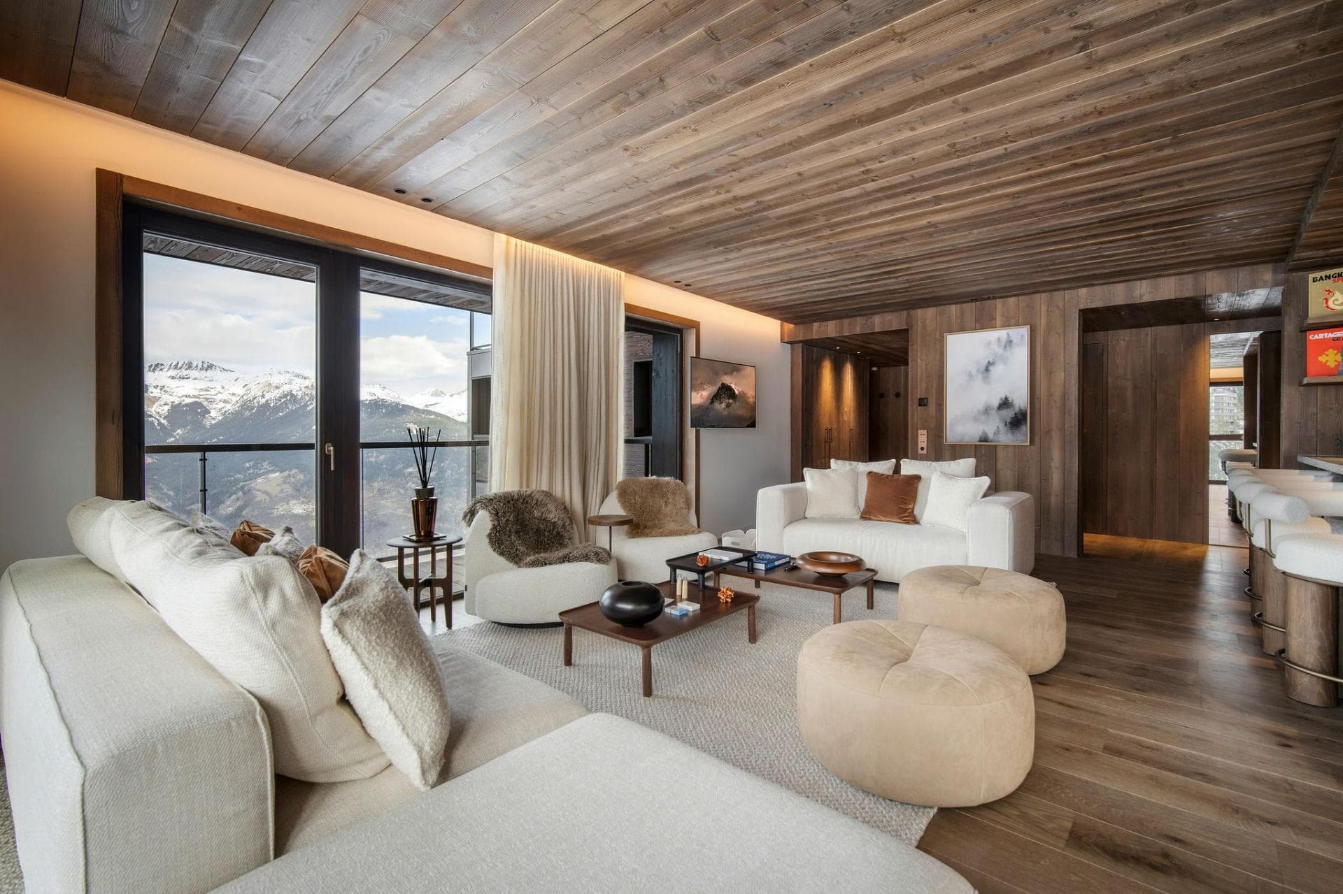 Living area with mountain views, wood-paneled ceiling, and bar seating