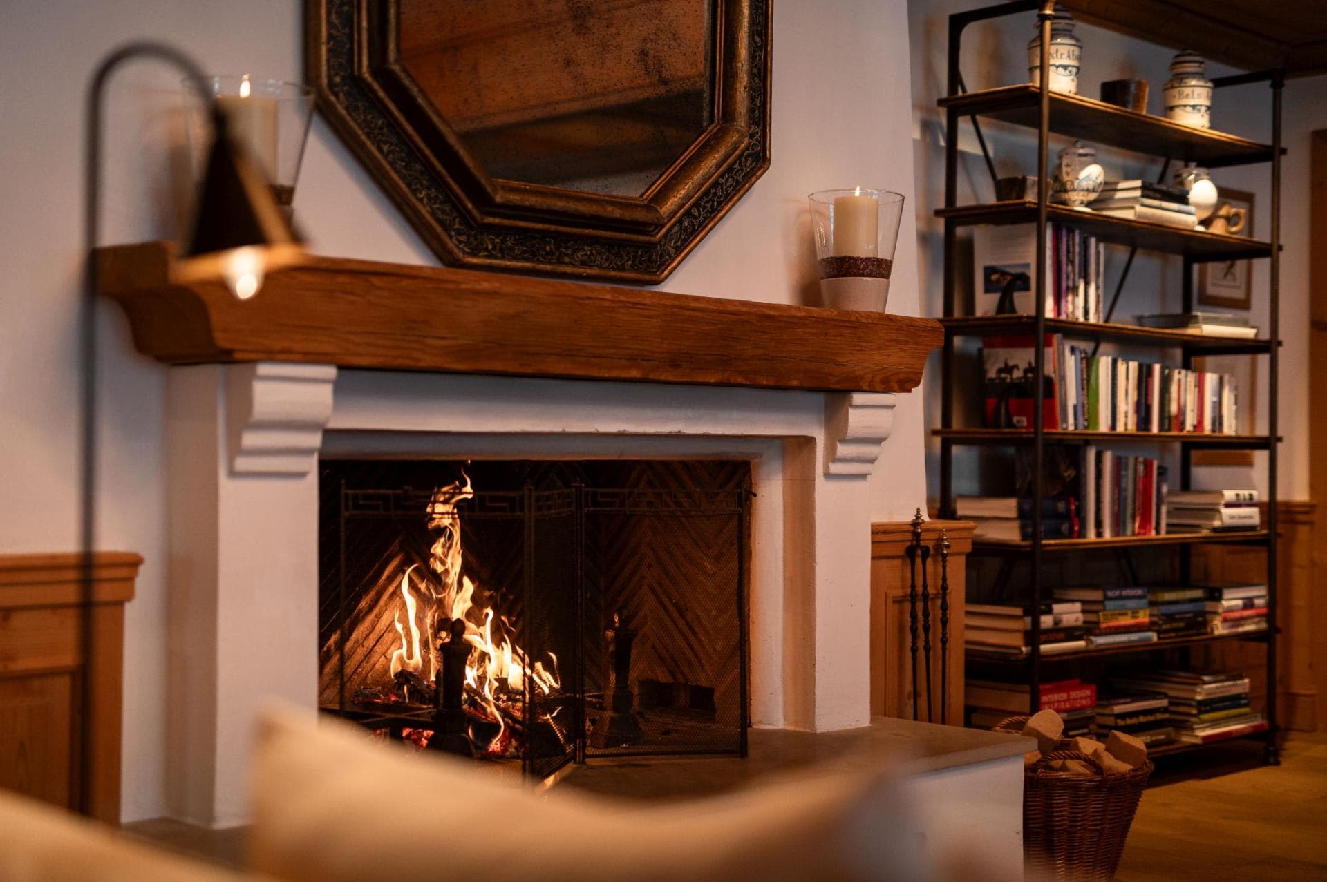 Wood-burning fireplace with herringbone brick interior and library shelving