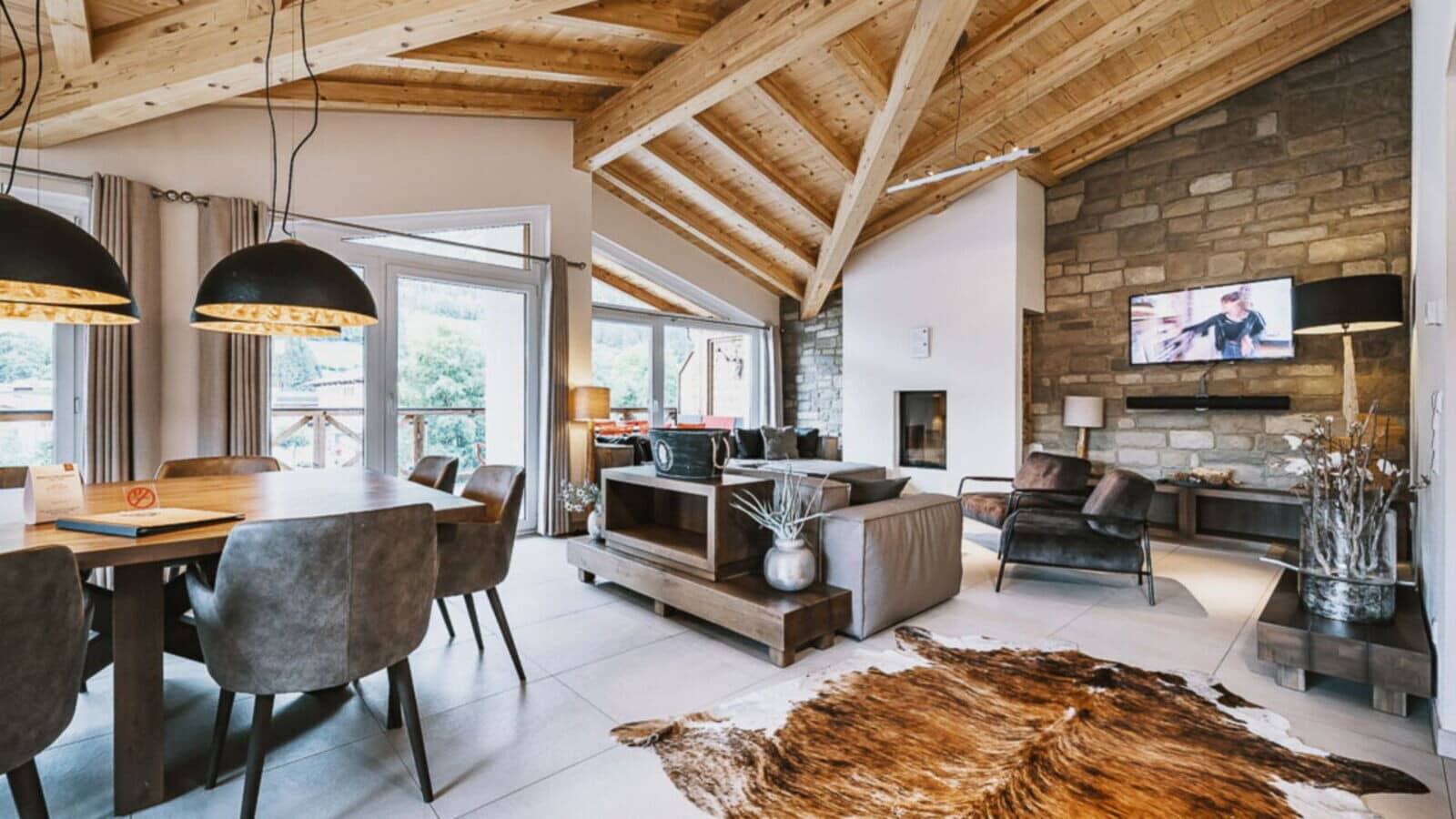 Open-plan living area with vaulted timber ceilings and fireplace