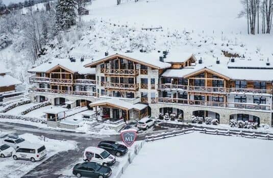Ski-in lodge exterior with private balconies and on-site guest parking