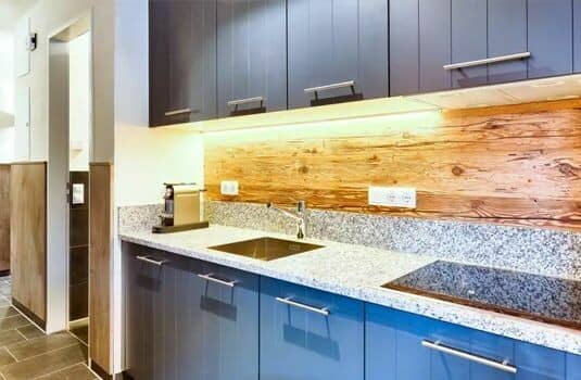 Kitchenette featuring granite countertops, induction cooktop, and Nespresso coffee machine