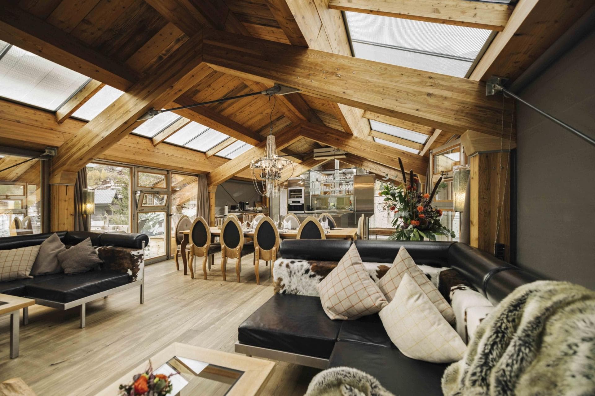 Open-plan living area with vaulted skylights and dining for 10