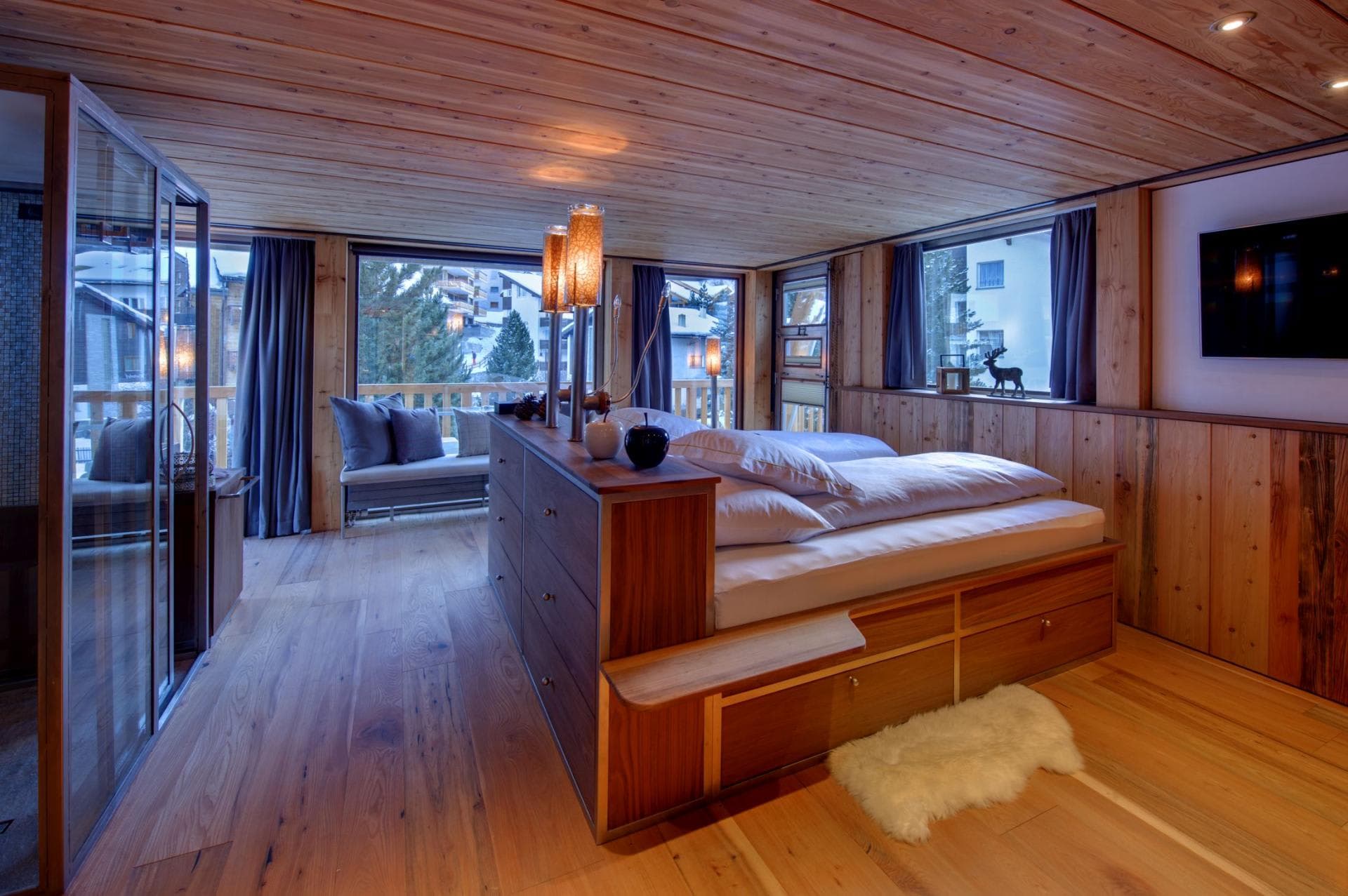 Wood-paneled bedroom with integrated storage and private balcony access