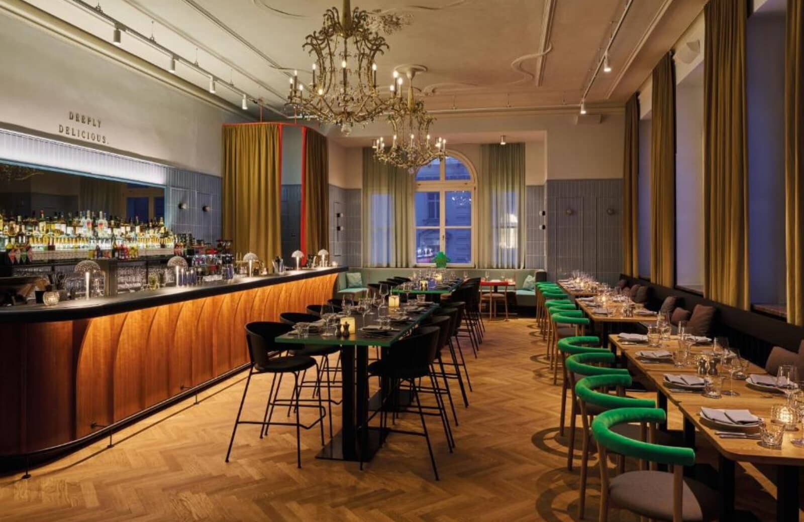 On-site restaurant and bar with herringbone floors and chandelier lighting