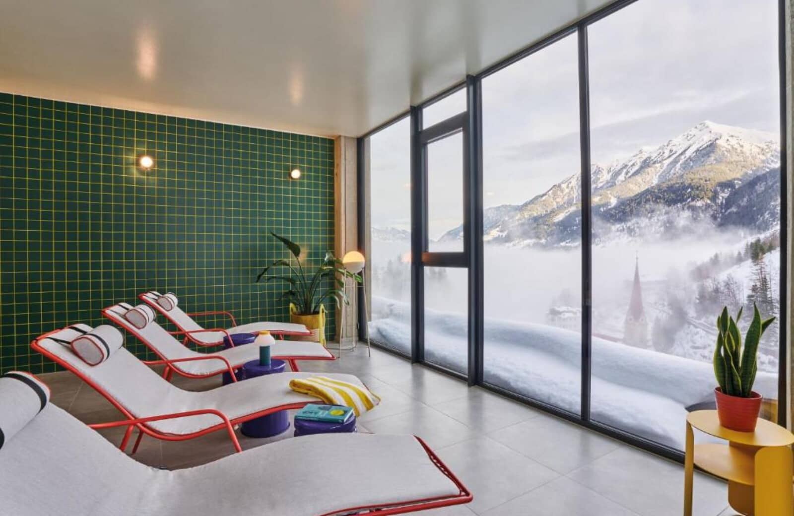 Indoor lounge area with floor-to-ceiling mountain and valley views