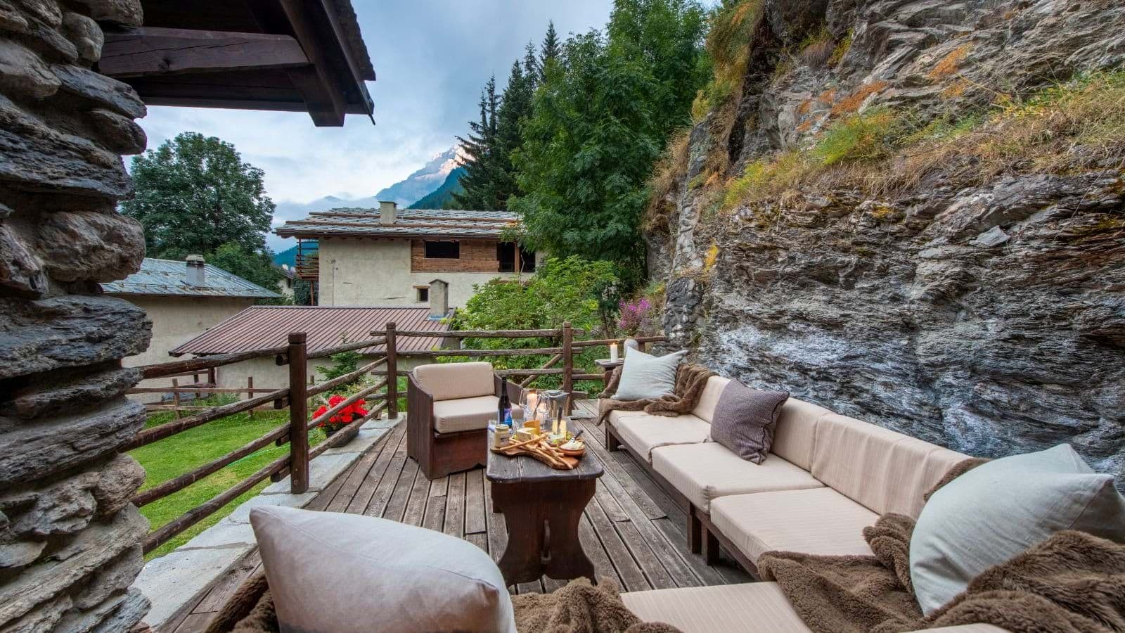 Stone terrace with integrated rock wall and mountain views