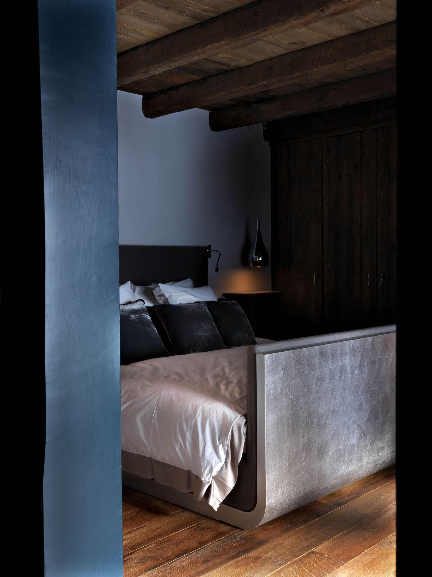 Bedroom with queen bed, exposed timber beams, and built-in closet storage
