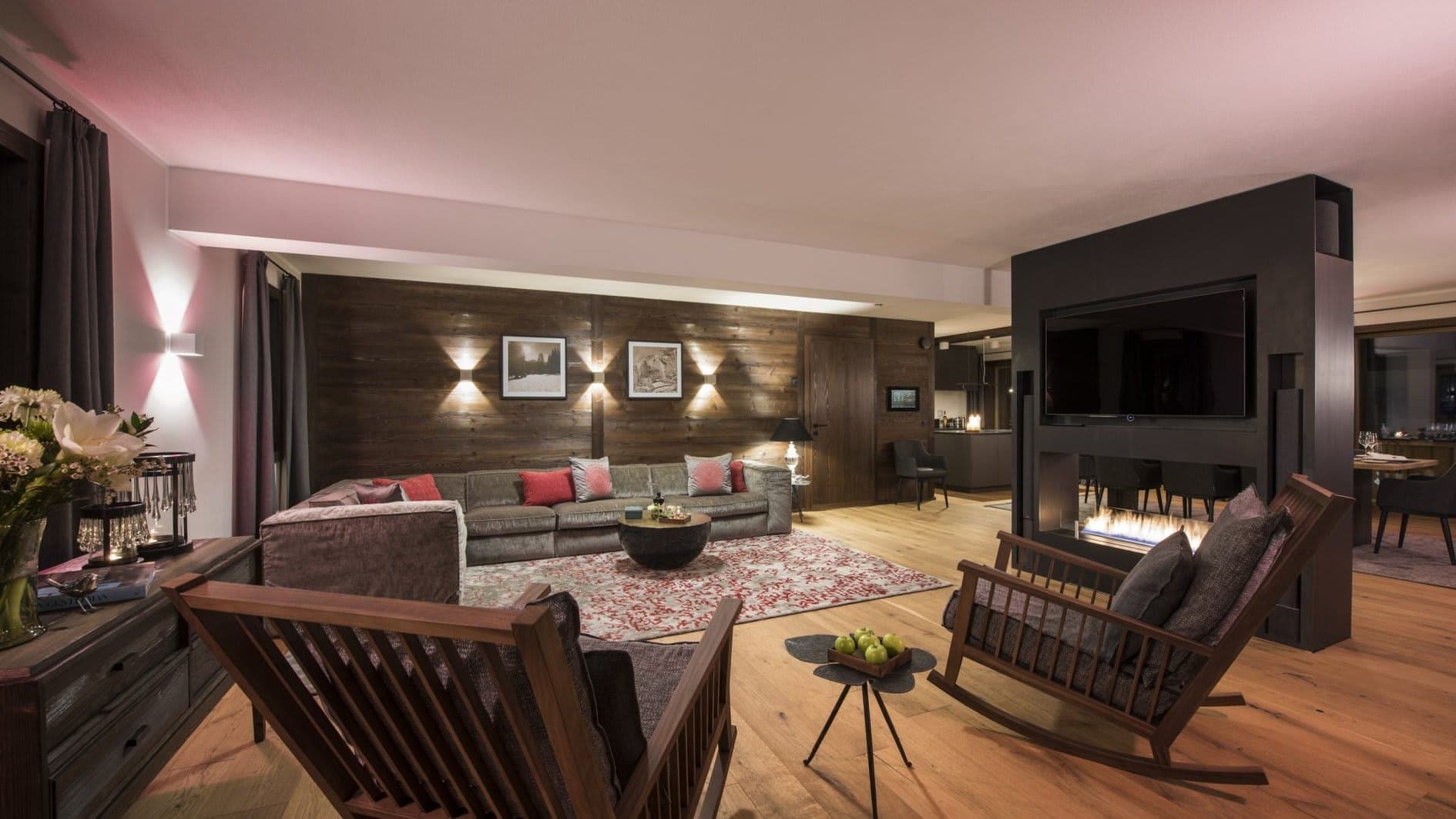 Living area with gas fireplace, wall-mounted TV, and reclaimed wood paneling