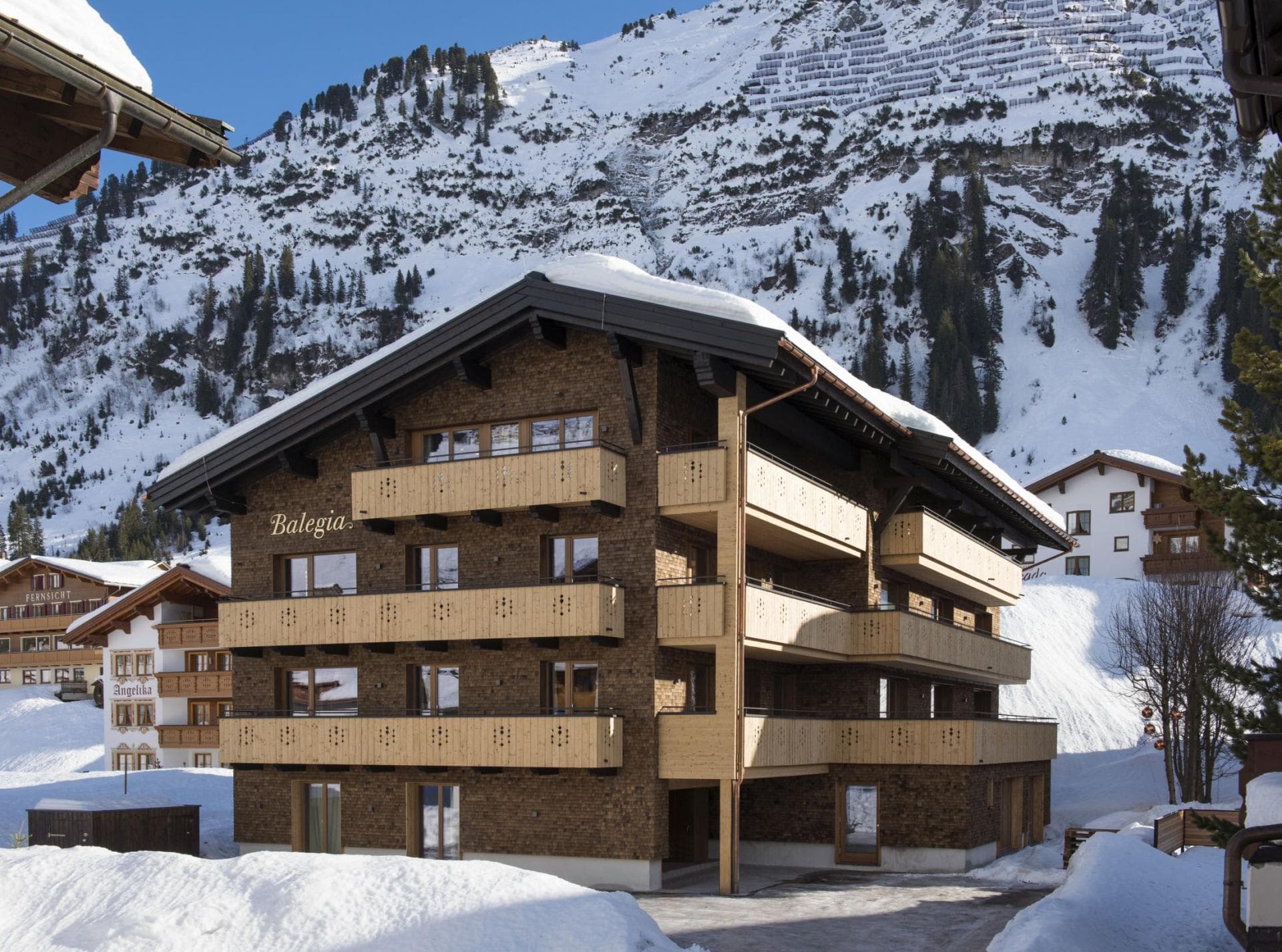 Chalet Balegia exterior with private balconies and mountain backdrop