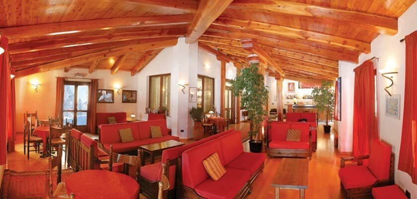 Lounge area with exposed timber beams and cocktail bar access