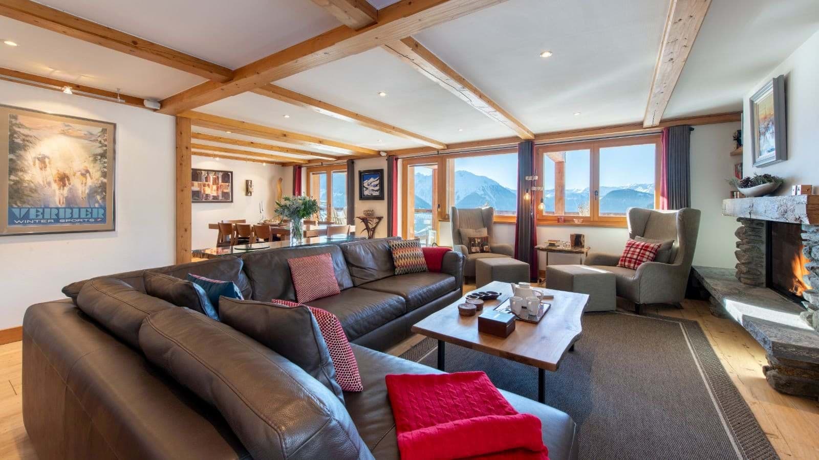 Living area with wood-burning fireplace and mountain-view windows