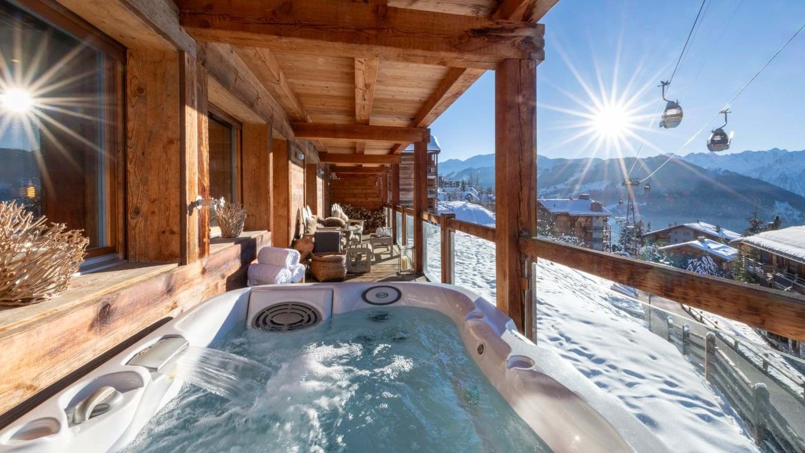 Covered balcony hot tub with mountain views and gondola access