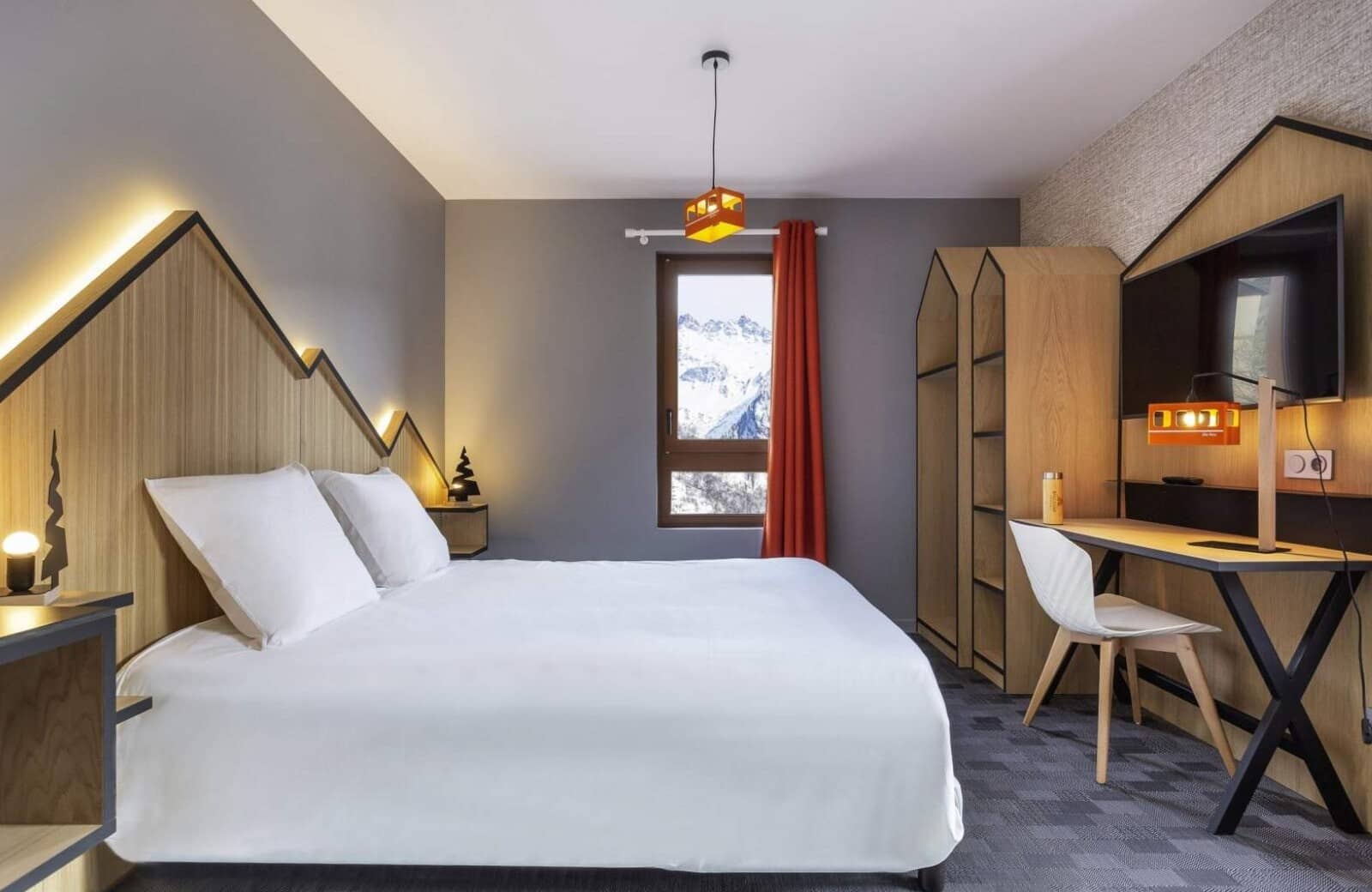 Guest bedroom with king bed, workstation, and mountain peak views