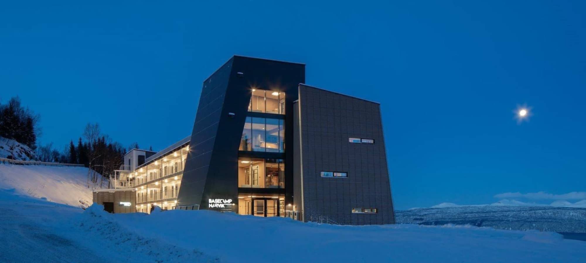 Basecamp Narvik exterior with ski-in access and glass-fronted mountain views