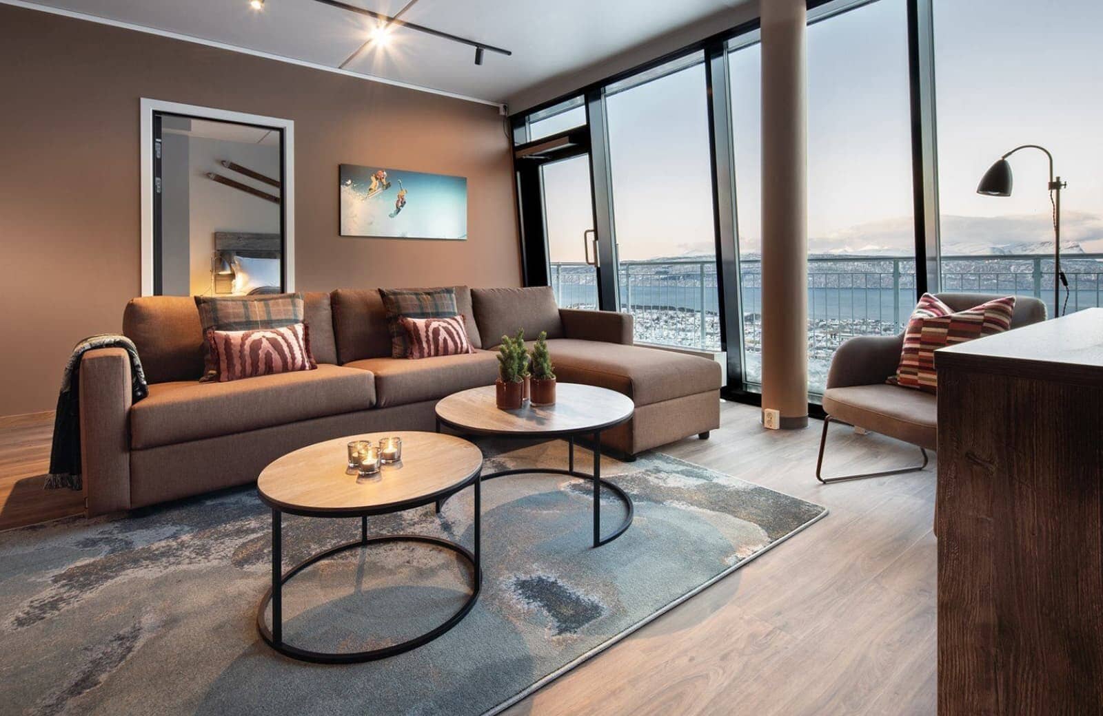 Living area with sectional seating and floor-to-ceiling city and water views