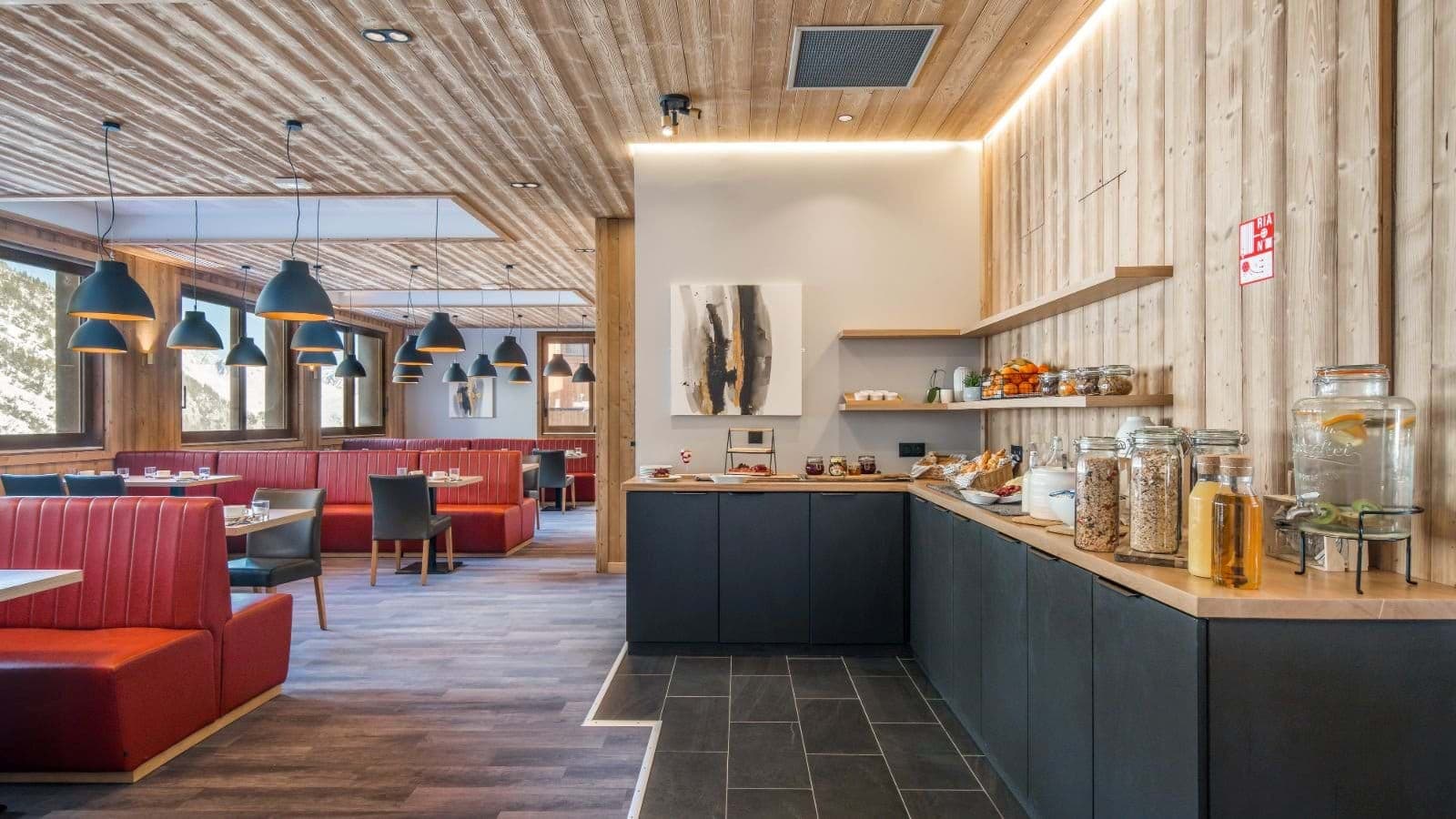 Breakfast buffet station and dining area with booth seating