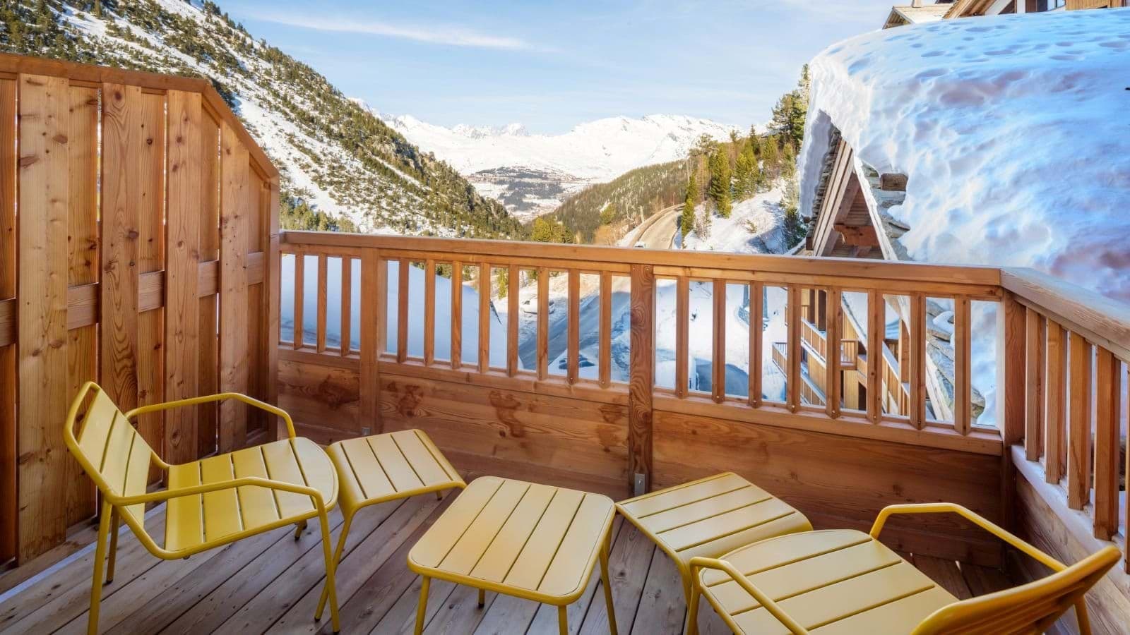 Private balcony with lounge seating and panoramic Alpine mountain views