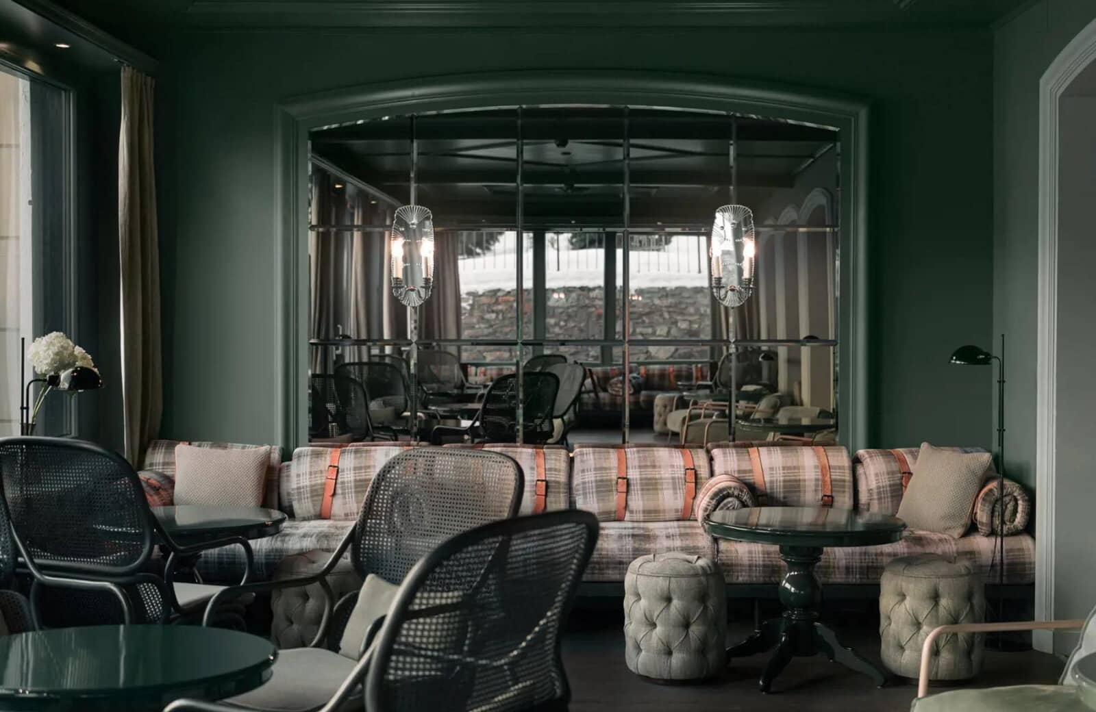 Lounge area with banquette seating and mirrored wall reflecting snowy outdoors
