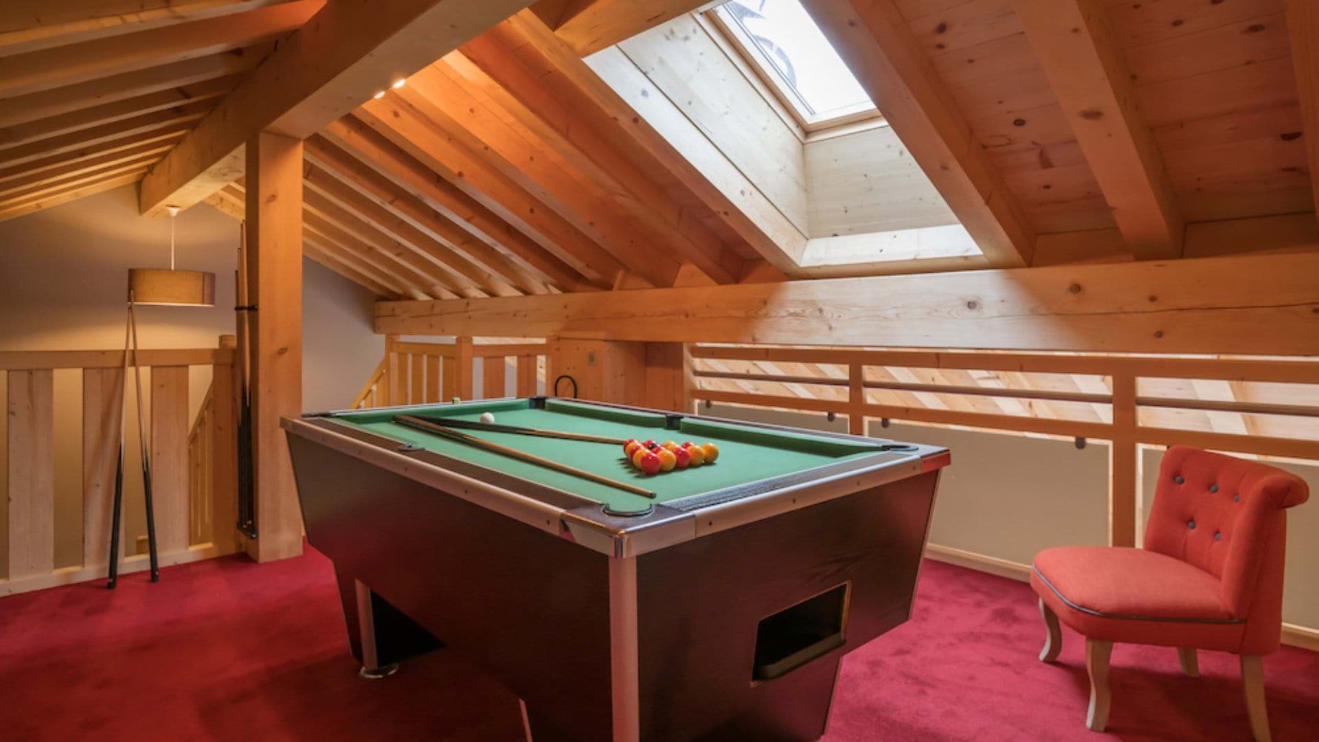 Mezzanine games area with pool table and skylight