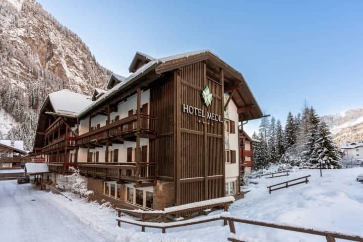 Alpine lodge exterior with private balconies and mountain views