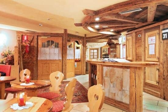 Reception area with wood-paneled counter and heart-motif seating