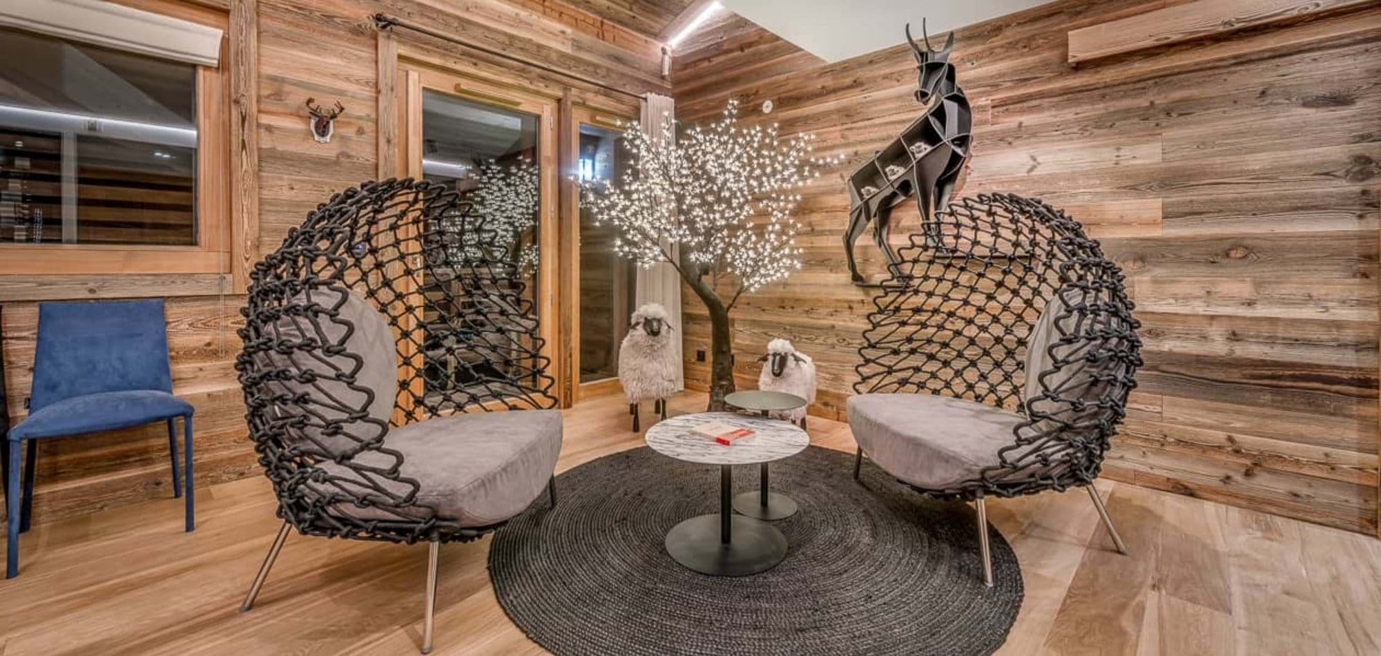 Seating area with rope lounge chairs and wood-paneled walls