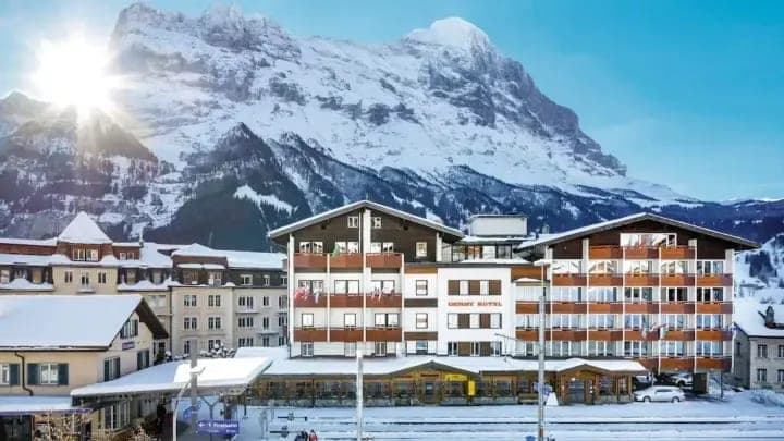 Hotel exterior adjacent to Grindelwald train station with Eiger north face views