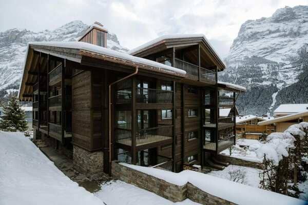 Ski-in chalet exterior with private balconies and mountain views