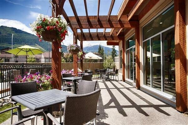 Shared patio with pergola and mountain views; café-style seating for 12